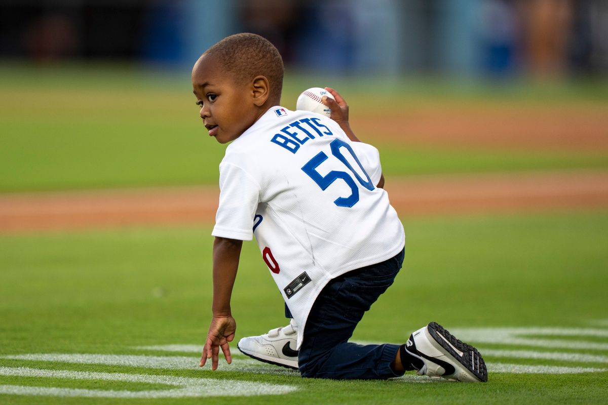 Los Angeles Dodgers infielder Mookie Betts' (50) son warming up for first pitch before an MLB baseball game against the Baltimore Orioles on June 19th, 2026 in Los Angeles, CA.
