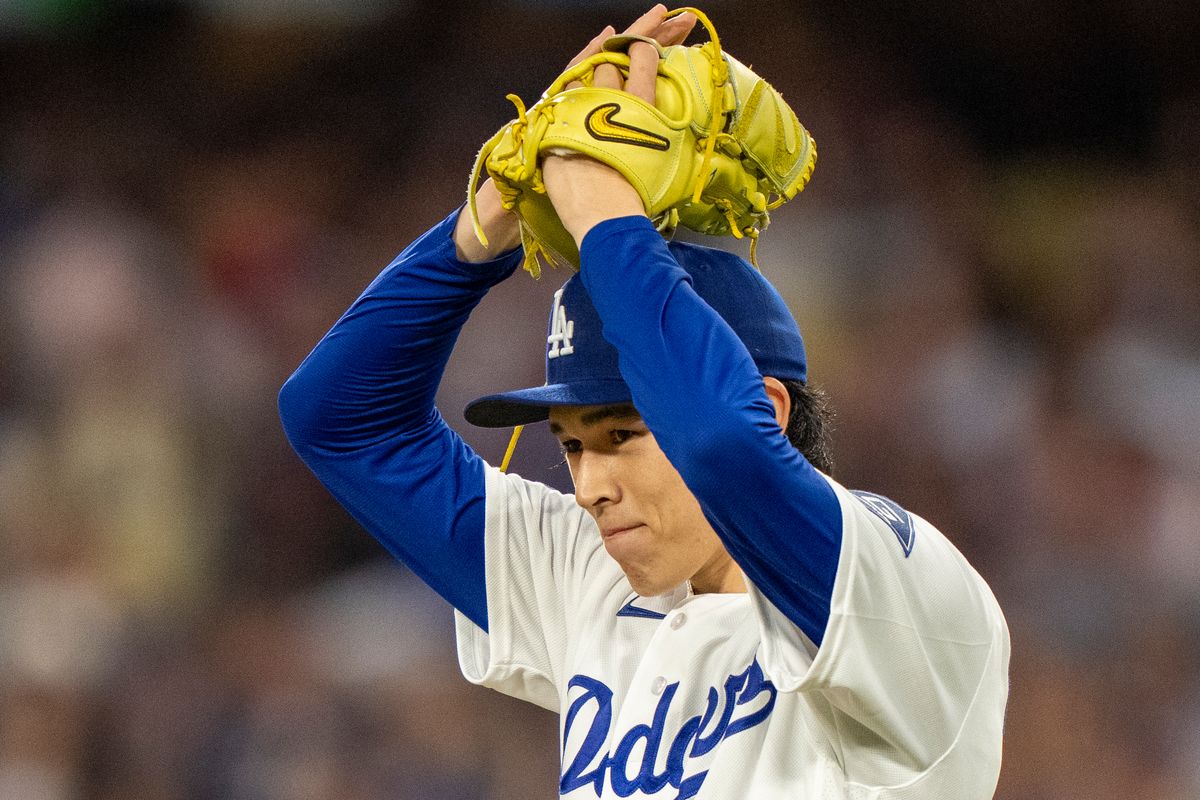 Los Angeles Dodgers pitcher Roki Sasaki (11) smiles after a batter is tagged out at second during an MLB baseball game against the Baltimore Orioles on June 19th, 2026 in Los Angeles, CA.