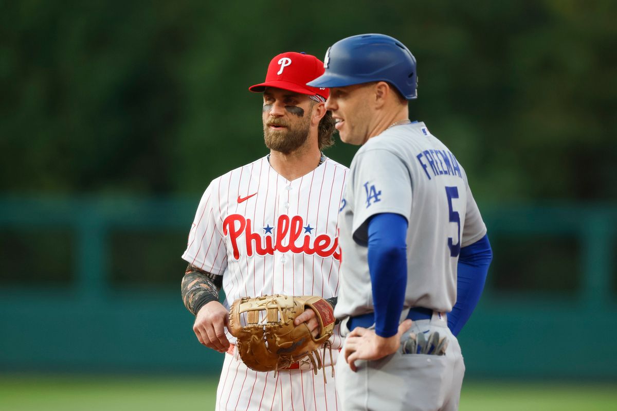 Bryce Harper #3 of the Philadelphia Phillies talks with Freddie Freeman #5 of the Los Angeles Dodgers during a game at Citizens Bank Park on July 20, 2026 in Philadelphia, Pennsylvania.