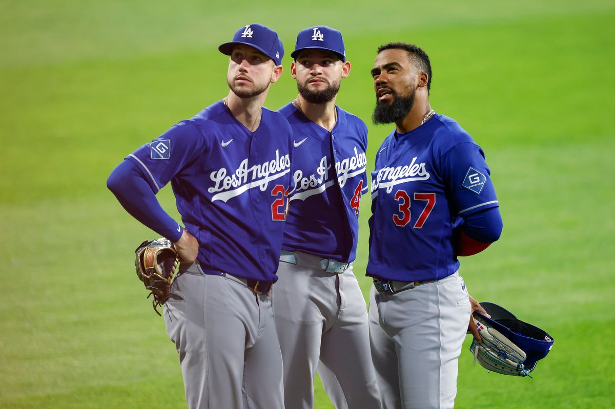 Kyle Tucker #23, Andy Pages #44, and Teoscar Hernandez #37 of the Los Angeles Dodgers gather in the outfield against the Philadelphia Phillies at Citizens Bank Park on July 22, 2026 in Philadelphia, Pennsylvania.