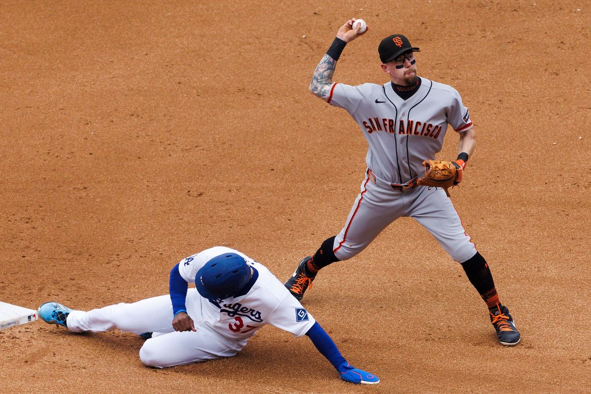 Christian Koss #50 of the San Francisco Giants throws to first base as Teoscar Hernandez #37 of the Los Angeles Dodgers slides during the game at Dodger Stadium on September 20, 2026 in Los Angeles, California. Christian Koss #50 of the San Francisco Giants throws to first base as Teoscar Hernandez #37 of the Los Angeles Dodgers slides during the game at Dodger Stadium on September 20, 2026 in Los Angeles, California.