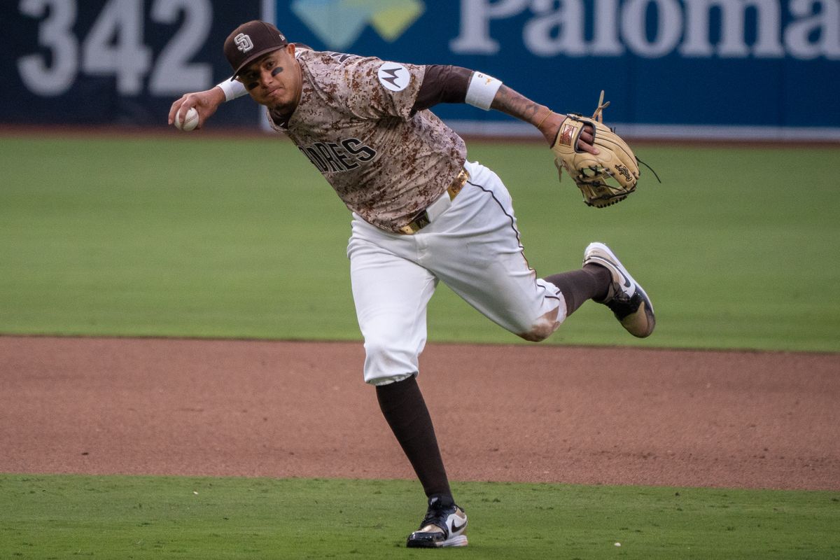 San Diego Padres Third Baseman, Manny Machado (13), makes a tough throw to first during an MLB Baseball game against the Atlanta Braves at Petco Park in San Diego, CA, on March 30, 2025. San Diego Padres Third Baseman, Manny Machado (13), makes a tough throw to first during an MLB Baseball game against the Atlanta Braves at Petco Park in San Diego, CA, on March 30, 2025.