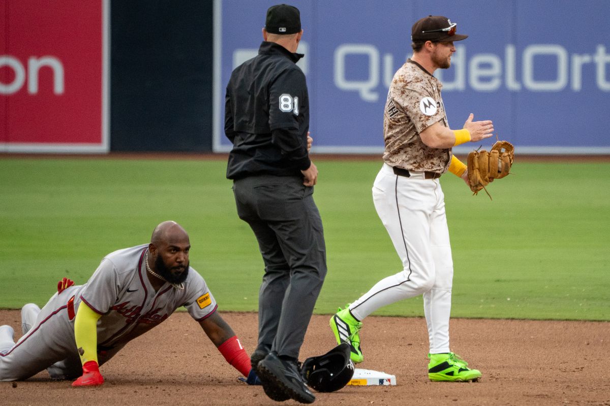 San Diego Padres Infielder, Jake Cronenworth (9), slaps his glove in celebration after finishing off a double play during an MLB Baseball game against the Atlanta Braves at Petco Park in San Diego, CA, on March 30, 2025. San Diego Padres Infielder, Jake Cronenworth (9), slaps his glove in celebration after finishing off a double play during an MLB Baseball game against the Atlanta Braves at Petco Park in San Diego, CA, on March 30, 2025.