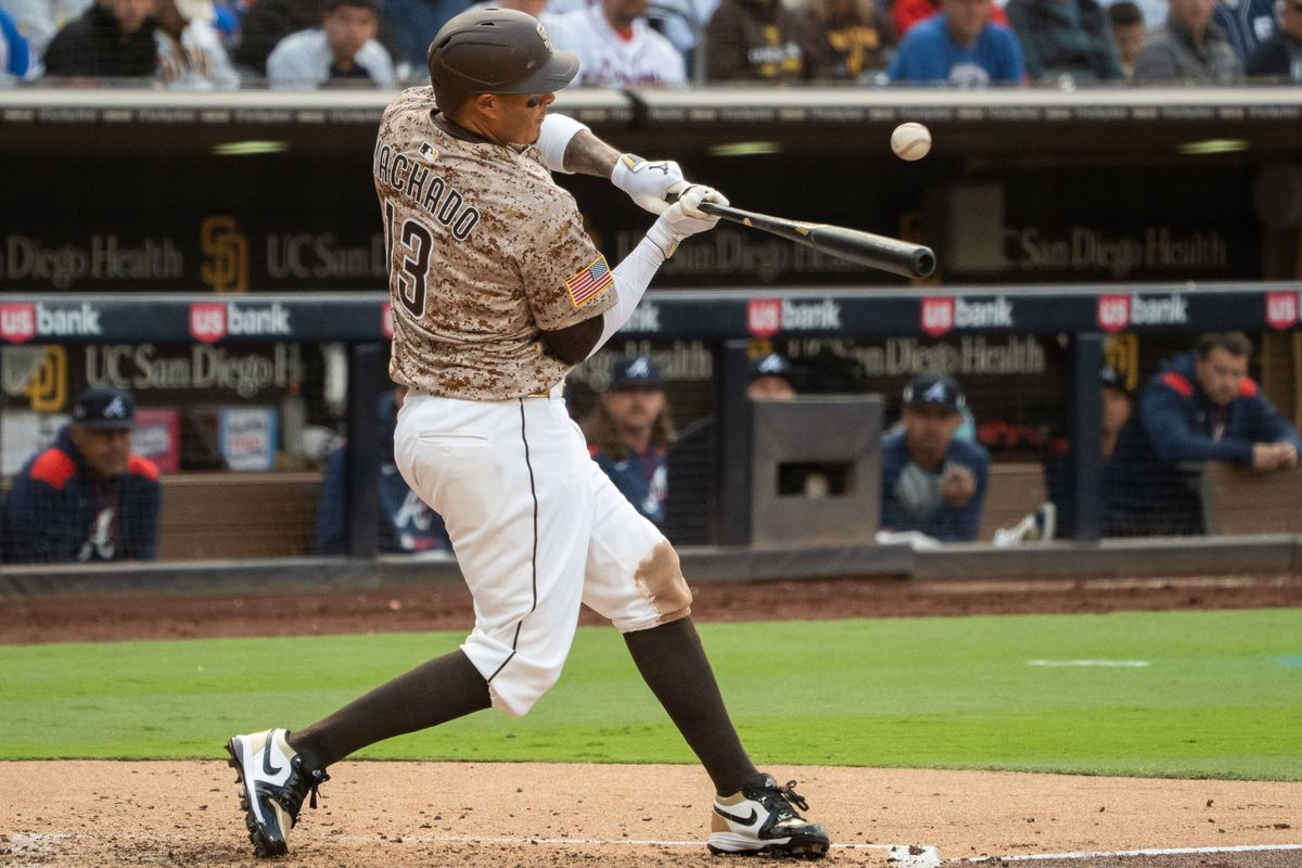 San Diego Padres Third Baseman, Manny Machado (13), hits a check-swing bloop during an MLB Baseball game against the Atlanta Braves at Petco Park in San Diego, CA, on March 30, 2025. San Diego Padres Third Baseman, Manny Machado (13), hits a check-swing bloop during an MLB Baseball game against the Atlanta Braves at Petco Park in San Diego, CA, on March 30, 2025.