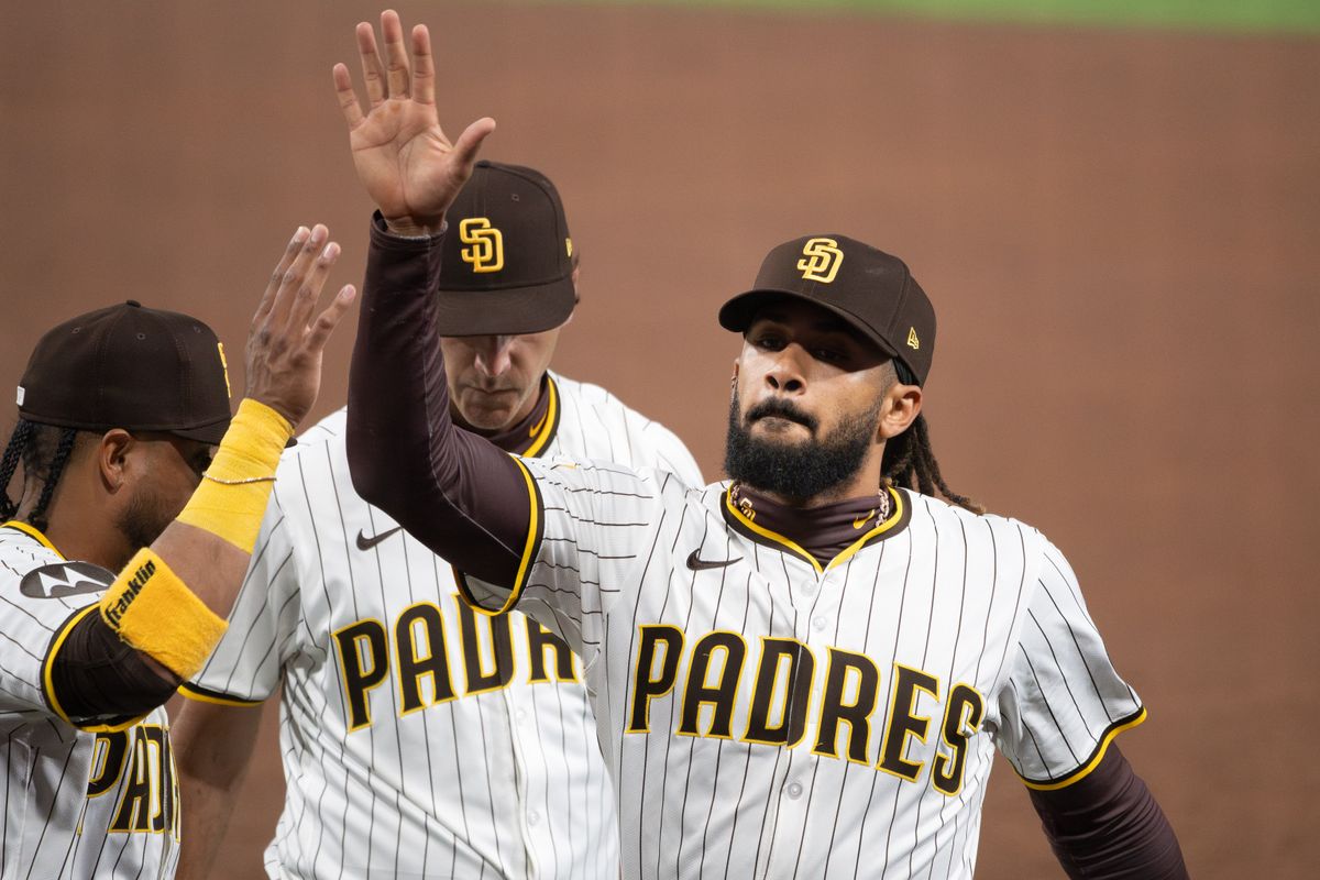 San Diego Padres Outfielder, Fernando Tatis Jr. (23), high-fives his teammates after making a diving catch during an MLB Baseball game against the Cleveland Guardians at Petco Park in San Diego, CA, on March 31, 2025. San Diego Padres Outfielder, Fernando Tatis Jr. (23), high-fives his teammates after making a diving catch during an MLB Baseball game against the Cleveland Guardians at Petco Park in San Diego, CA, on March 31, 2025.