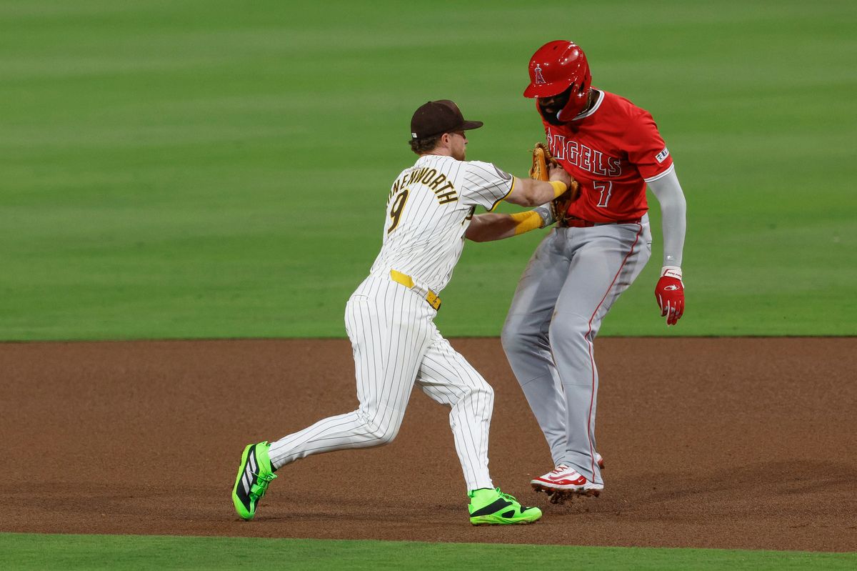Jake Cronenworth #9 of the San Diego Padres tags Jo Adell #7 of the Los Angeles Angels on a double play at Petco Park at Petco Park on May 14, 2025 in San Diego, California.