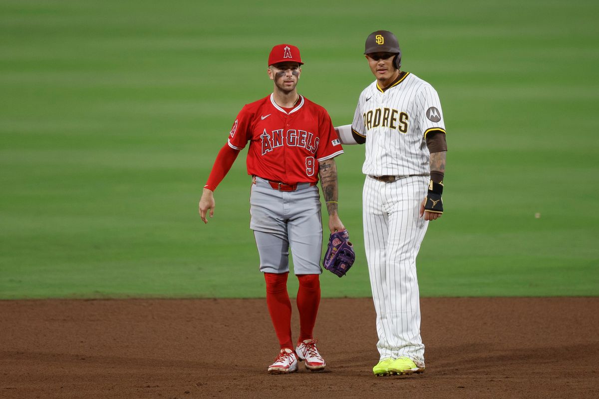 Fernando Tatis Jr. #23 of the San Diego Padres and Zach Neto #9 of the Los Angeles Angels on the field at Petco Park at Petco Park on May 14, 2025 in San Diego, California.