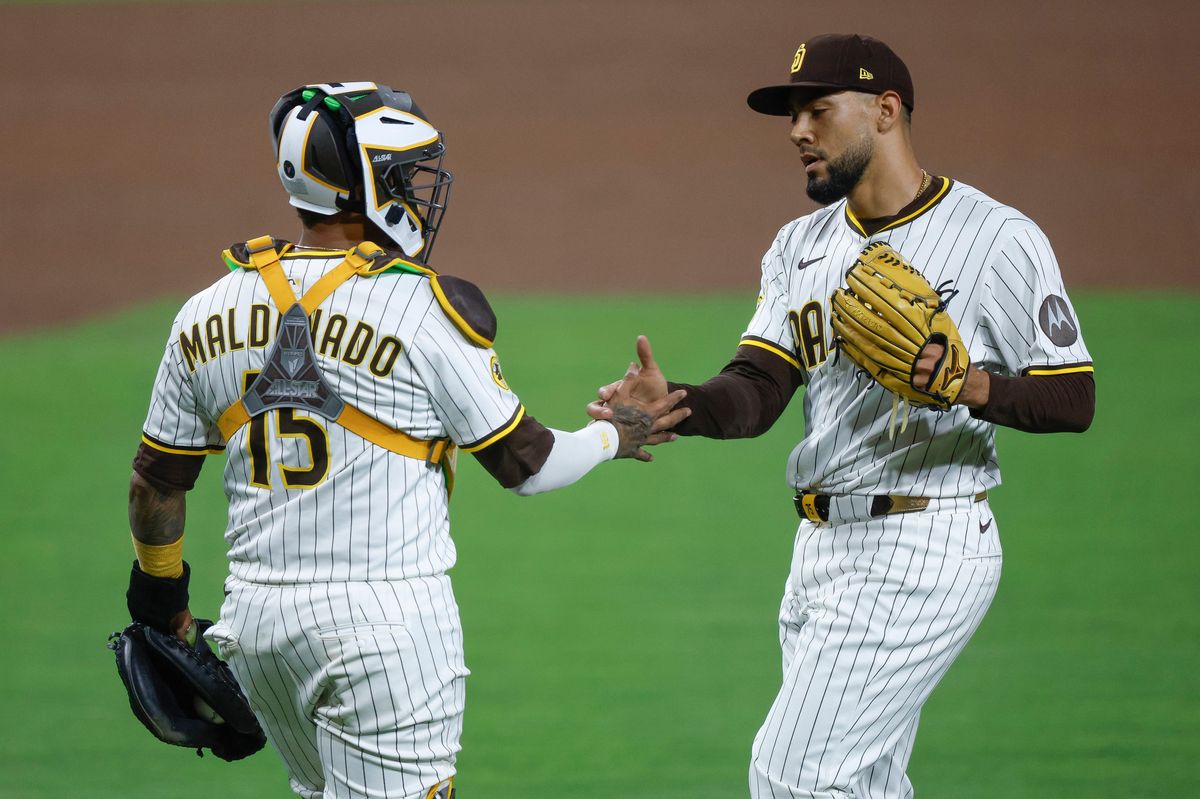 Robert Suarez #75 and Martin Maldonado #15 of the San Diego Padres celebrate a team victory over the Los Angeles Angels at Petco Park at Petco Park on May 14, 2025 in San Diego, California.