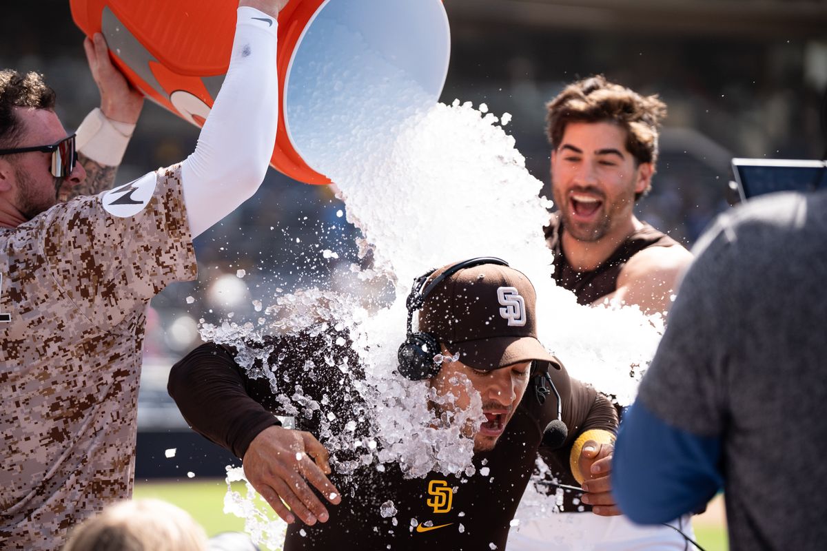 San Diego Padres players Jackson Merrill (3) and Tyler Wade (14) dump water on José Iglesias (7) after a walk-off win against the Kansas City Royals on June 22, 2025 at Petco Park in San Diego, CA. San Diego Padres players Jackson Merrill (3) and Tyler Wade (14) dump water on José Iglesias (7) after a walk-off win against the Kansas City Royals on June 22, 2025 at Petco Park in San Diego, CA.