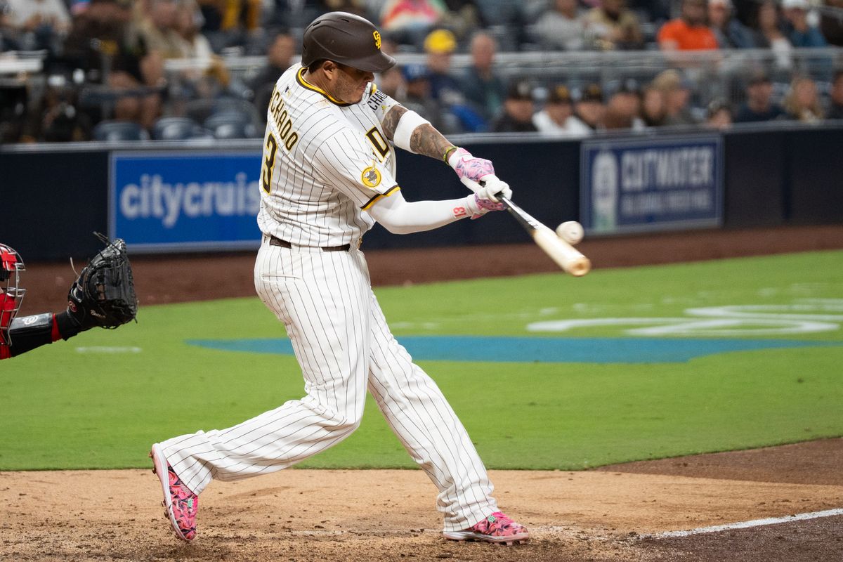 San Diego Padres third baseman Manny Machado (13) hits the ball during an MLB game against the Washington Nationals on June 23, 2025 at Petco Park in San Diego, CA.