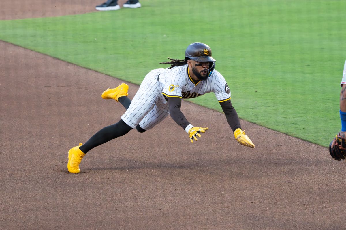 San Diego Padres Right fielder Fernando Tatis Jr. #23 diving into third base during a game against the Philadelphia Phillies on July 12, 2025 in San Diego, CA. San Diego Padres Right fielder Fernando Tatis Jr. #23 diving into third base during a game against the Philadelphia Phillies on July 12, 2025 in San Diego, CA.