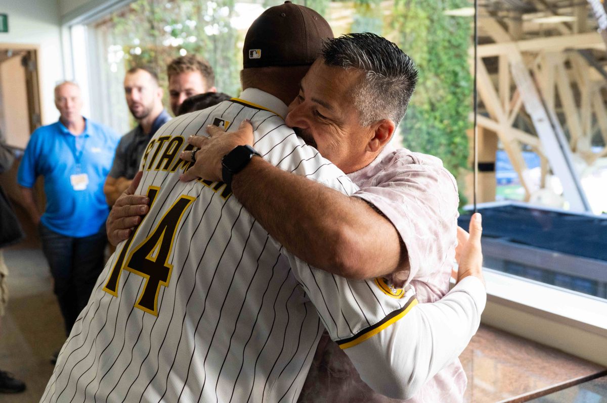 Craig Stammen hugs Padres pitching coach Ruben Niebla after being introduced as the new Padres manager, Monday November 10, 2025 in San Diego, Calif.