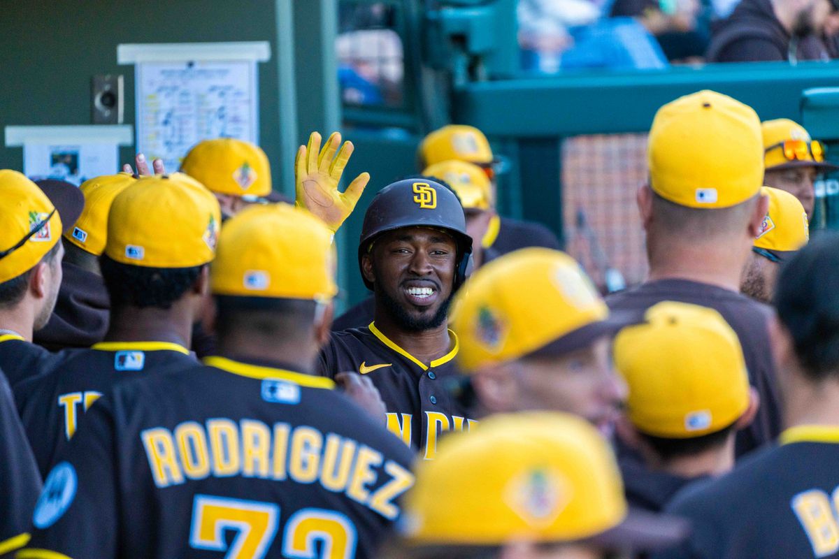San Diego Padres infielder Samad Taylor (0) is high fived by teammates during an MLB Spring Training game between the San Diego Padres and the Kansas City Royals, Saturday February 21, 2026 at Surprise Stadium in Surprise, AZ. San Diego Padres infielder Samad Taylor (0) is high fived by teammates during an MLB Spring Training game between the San Diego Padres and the Kansas City Royals, Saturday February 21, 2026 at Surprise Stadium in Surprise, AZ.