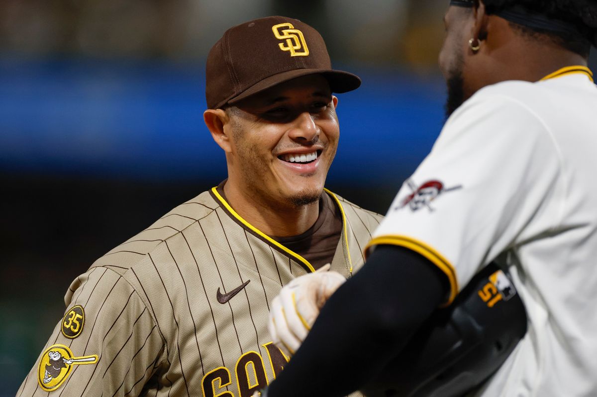 Manny Machado #13 smiles talking to Oneil Cruz #15 at PNC Park on April 6, 2025 in Pittsburgh.