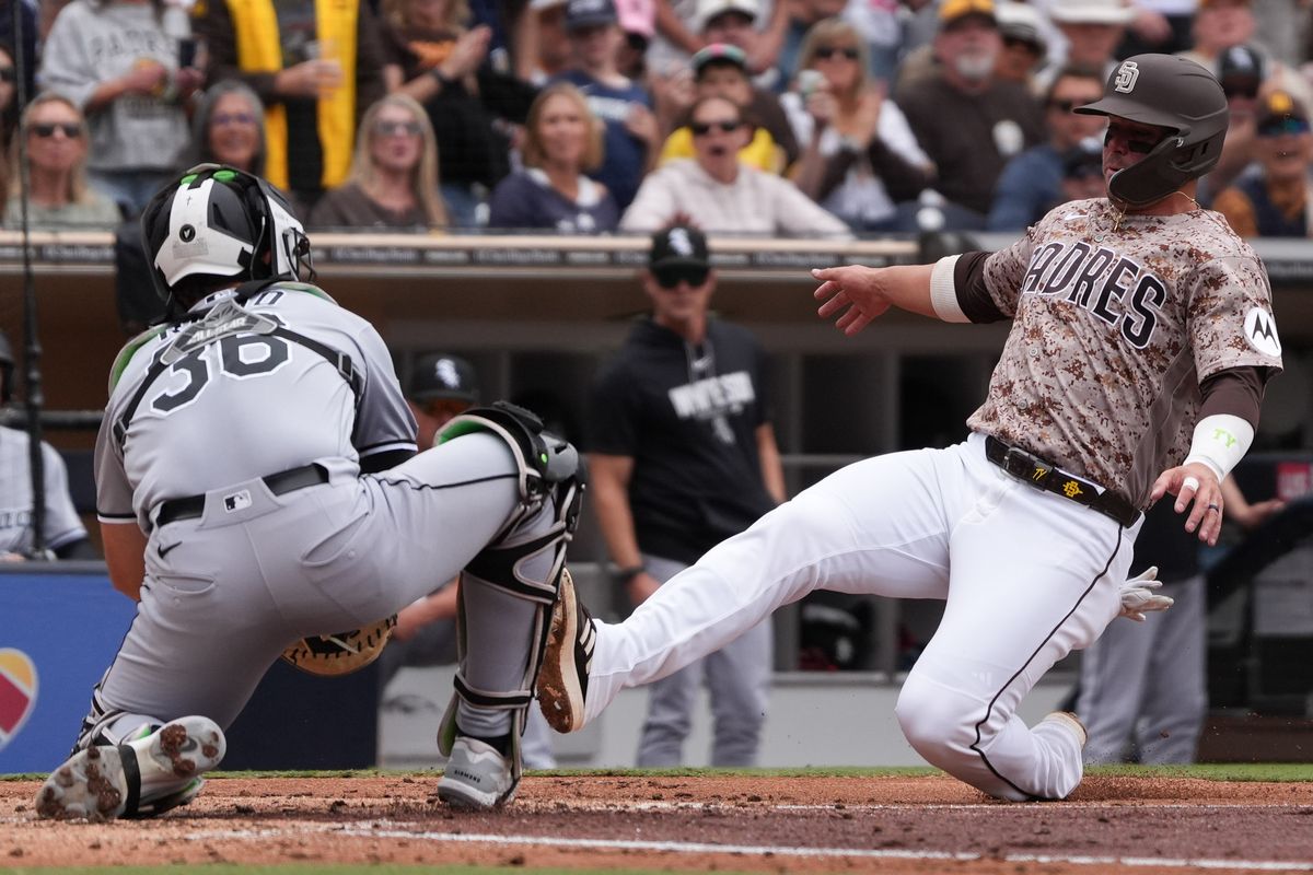 Padres first baseman Ty France (25) slides to home plate during an MLB baseball game against the White Sox, Sunday May 03, 2026 in San Diego, California.