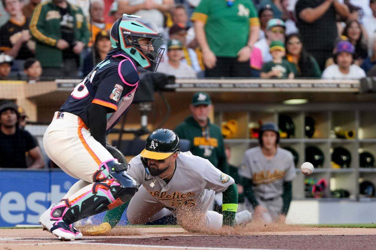 Athletics right fielder Carlos Cortes (26) slides home during an MLB baseball game against the Padres, Friday May 22, 2026 in San Diego, California.