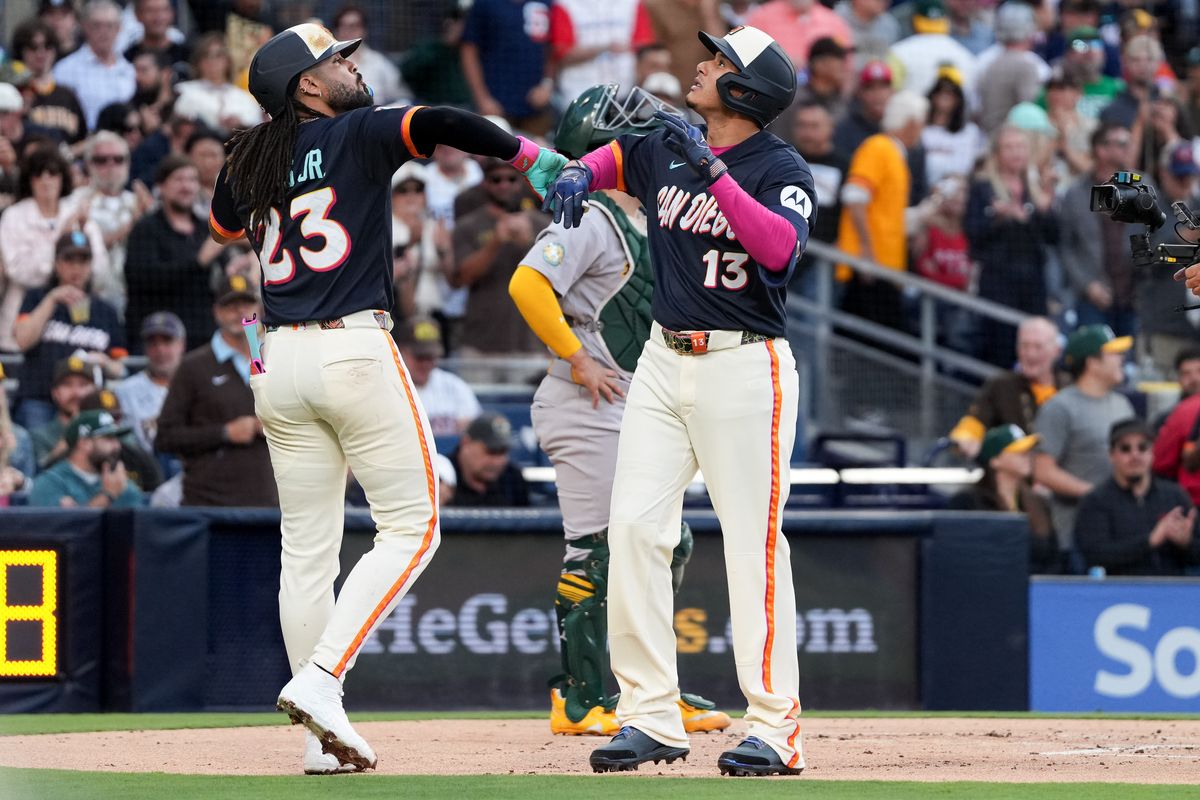 Padres third baseman Manny Machado (13) celebrates with Padres right fielder Fernando Tatis Jr. (23) after a hitting a home run during an MLB baseball game against the Athletics, Friday May 22, 2026 in San Diego, California.