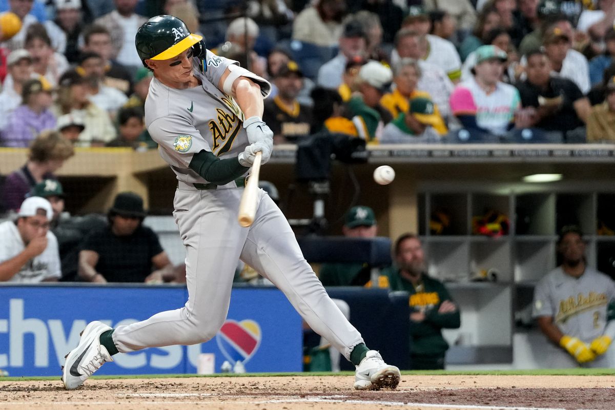 Athletics third baseman Zack Gelof (20) hits the ball during an MLB baseball game against the Padres, Friday May 22, 2026 in San Diego, California.