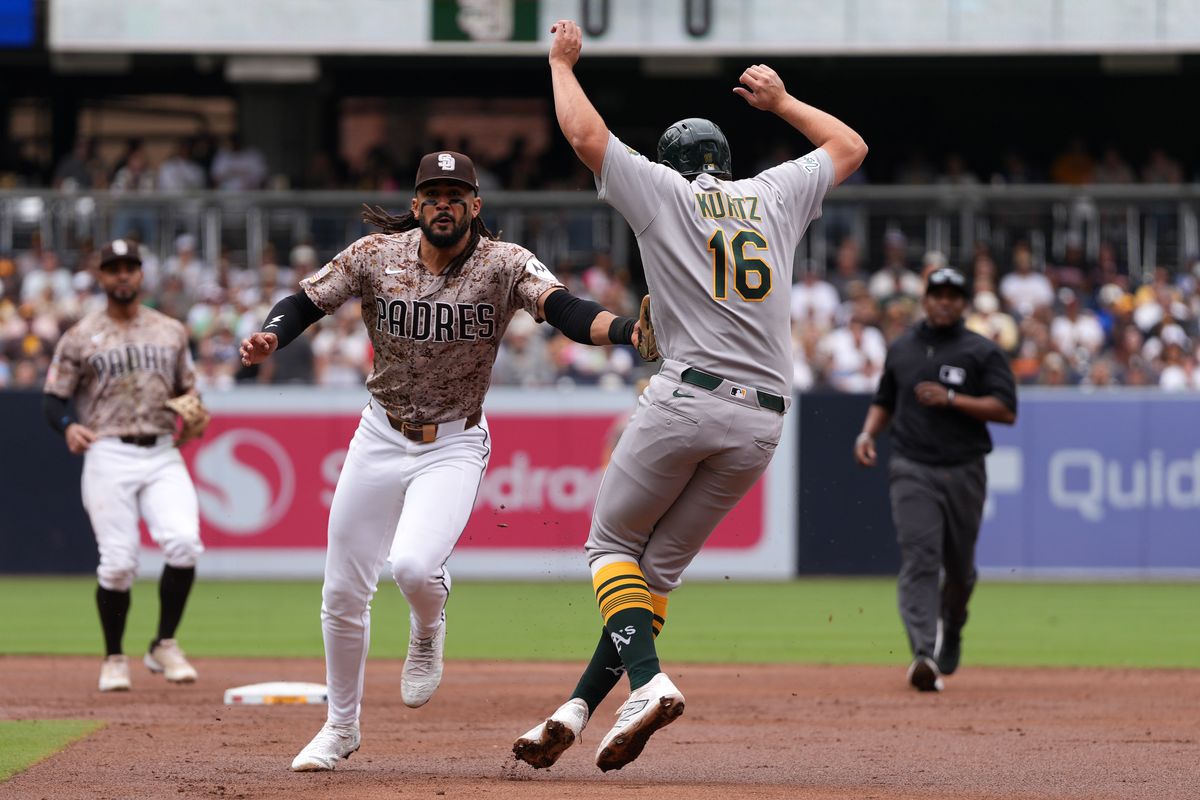 Padres right fielder Fernando Tatis Jr. (23) gets Athletics first baseman Nick Kurtz (16) out running to second base during an MLB baseball game against the Athletics, Sunday May 24, 2026 in San Diego, California. Padres right fielder Fernando Tatis Jr. (23) gets Athletics first baseman Nick Kurtz (16) out running to second base during an MLB baseball game against the Athletics, Sunday May 24, 2026 in San Diego, California.