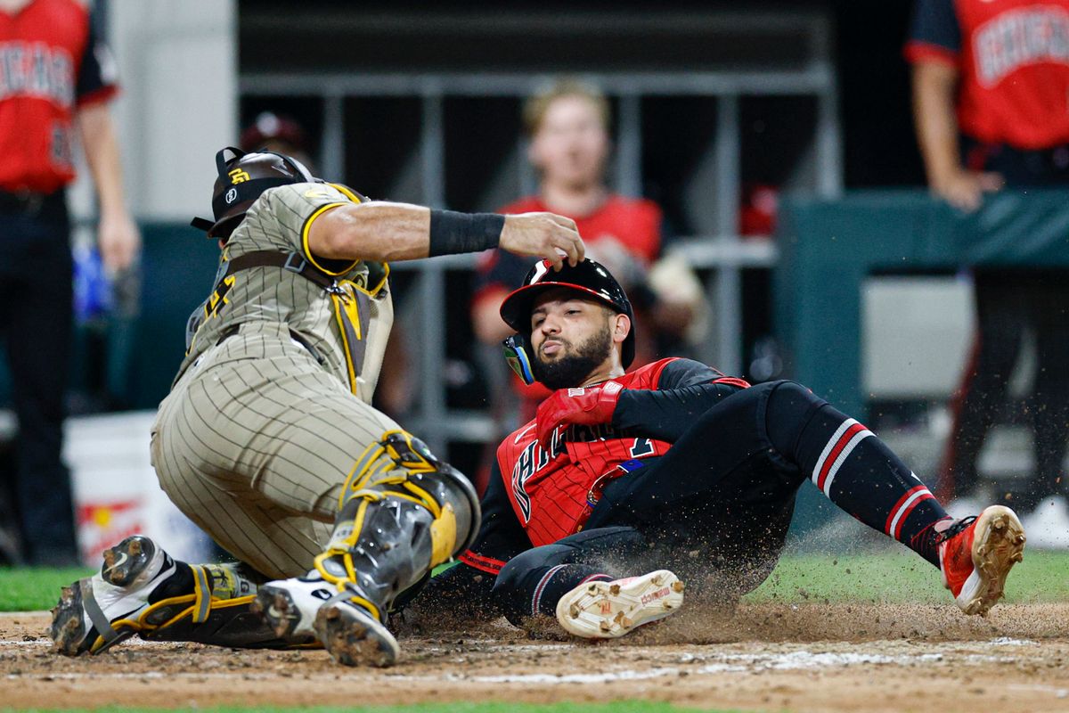 Chicago White Sox designated hitter Edgar Quero (7) scores against San Diego Padres catcher Freddy Fermin (54) during the fourth inning at Rate Field. Chicago White Sox designated hitter Edgar Quero (7) scores against San Diego Padres catcher Freddy Fermin (54) during the fourth inning at Rate Field.