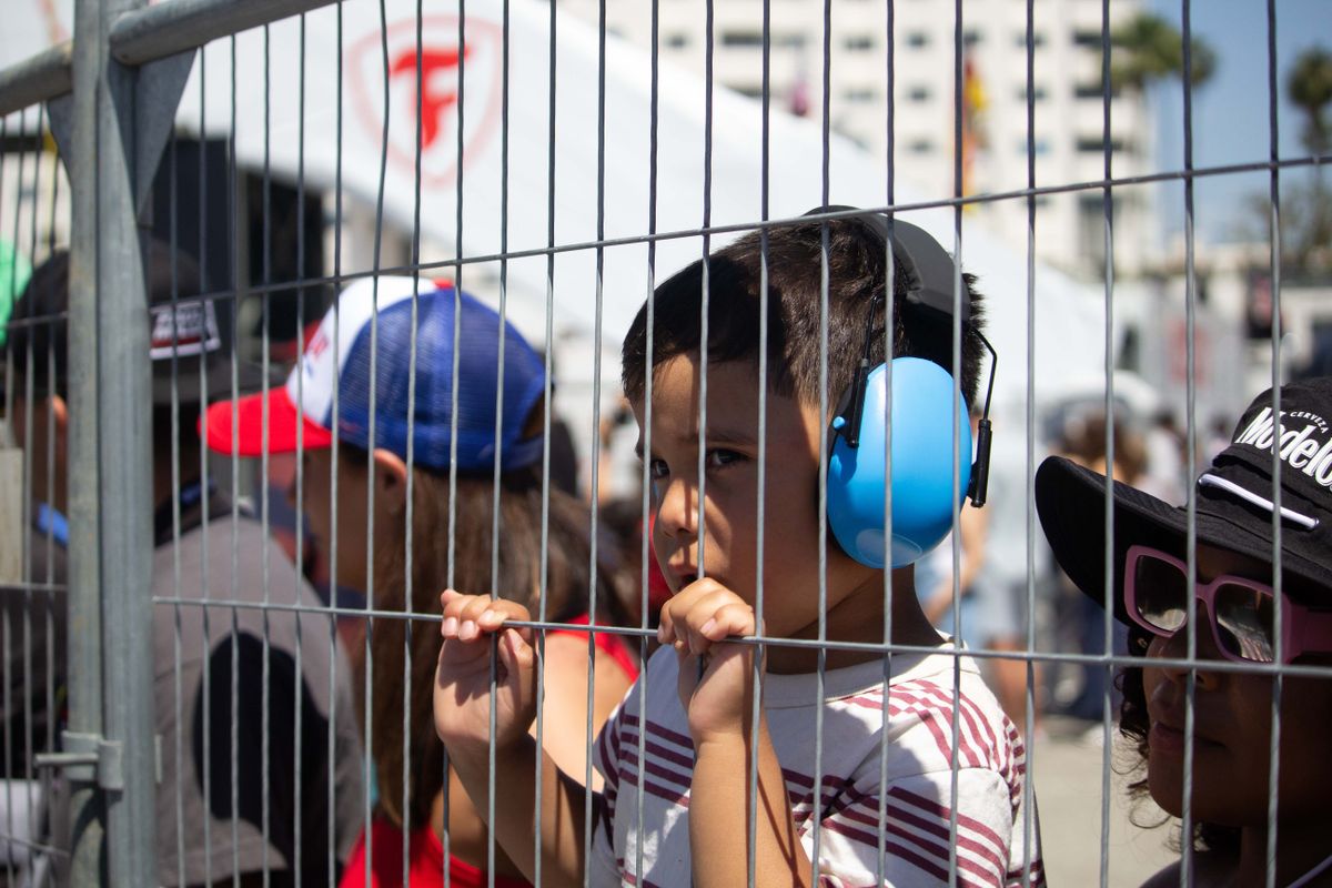 A young fan wearing ear protection looks on at the Friday practice sessions at the 2025 Acura Grand Prix of Long Beach. 
