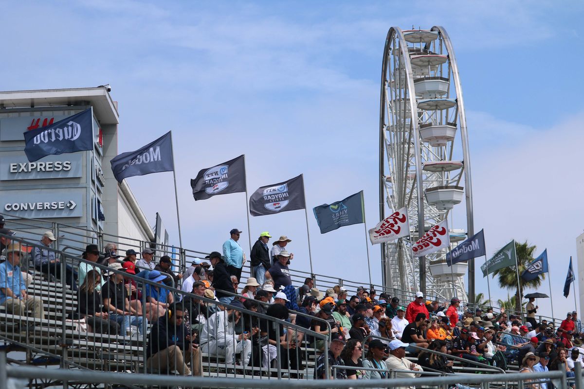 Fans gather in bleachers  in front of the Pike Outlets to watch races at the 2025 Acura Grand Prix of Long Beach. 