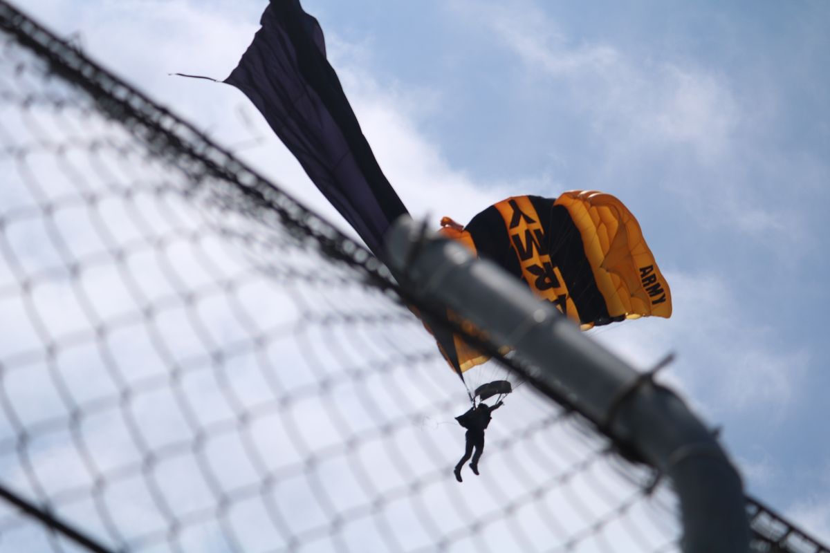 A parachuter lands during the opening ceremony of the GT America SportsCar race at the 2025 Acura Grand Prix of Long Beach.