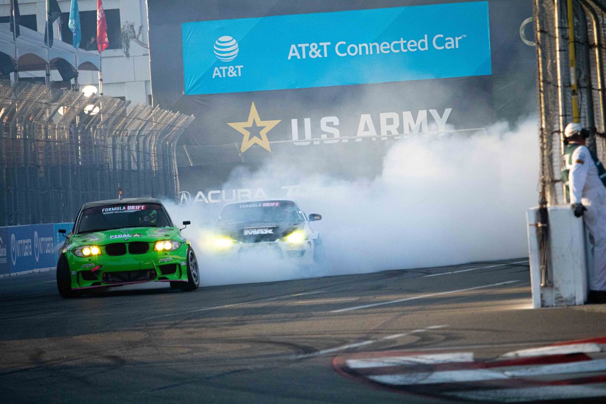 Rome Charpentier (green) covers Kasey Kohl (silver) in smoke during SuperDrift Challenge #2 at the 2025 Acura Grand Prix of Long Beach.