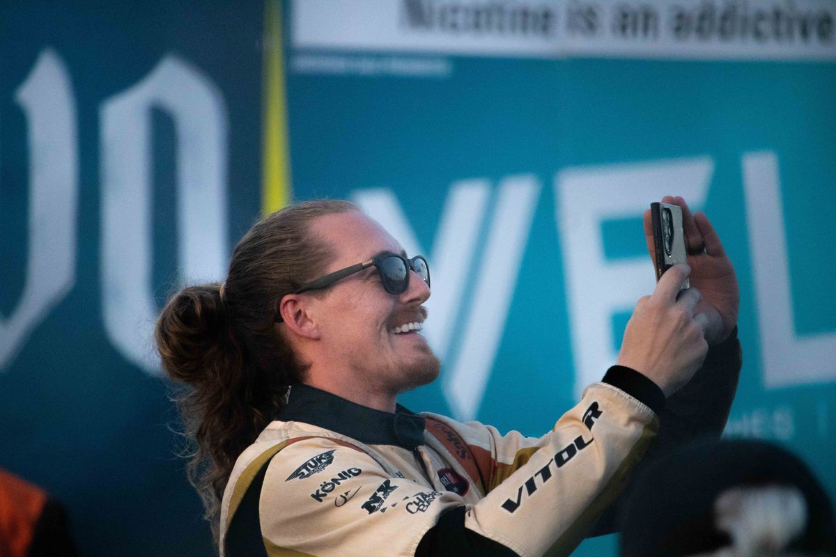 Daniel Stuke takes a picture of the crowd during driver introductions at SuperDrift Challenge #2 at the 2025 Acura Grand Prix of Long Beach.