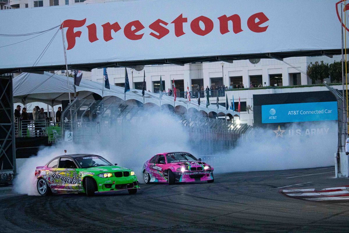 Rome Charpentier (green) and Margaritis Katsanidis drift around a turn during SuperDrift Challenge #2 at the 2025 Acura Grand Prix of Long Beach.
