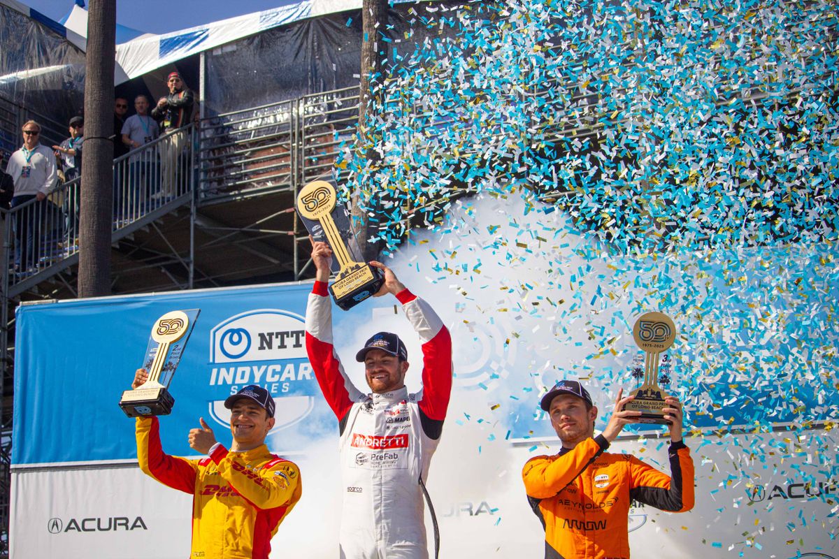 Kyle Kirkwood (center), Alex Palou (left) and Christian Lungaard (right) celebrate on the podium after the NTT IndyCar Series Grand Prix at the 2025 Acura Grand Prix of Long Beach.