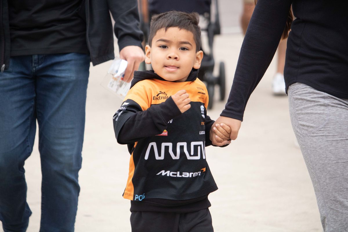A young fan wearing McLaren race gear at the 2025 Acura Grand Prix of Long Beach. 