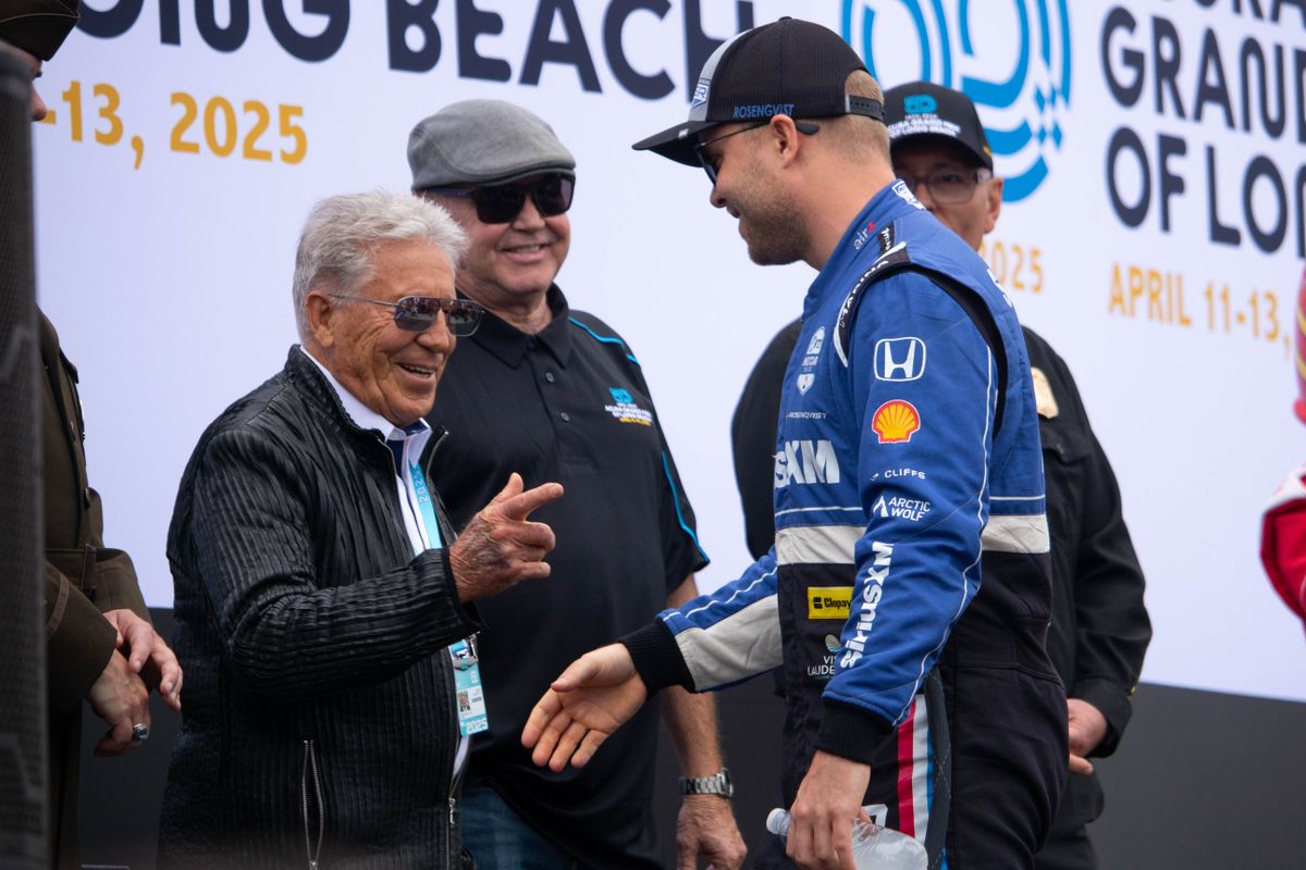 Mario Andretti embraces Felix Rosenqvist during driver introductions at the 2025 Acura Grand Prix of Long Beach.