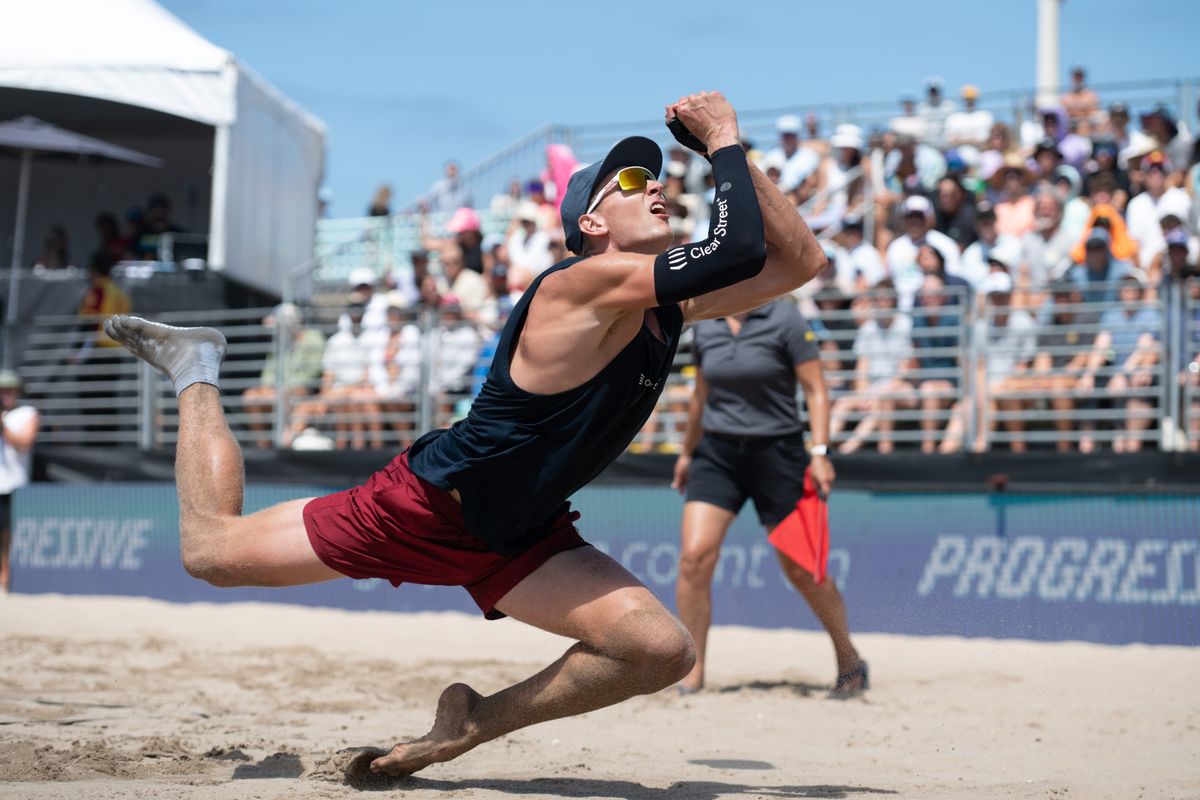 Miles Partain dives to keep the ball in play during the 2026 Manhattan Beach Open on Sunday, August 16, 2026 at Manhattan Beach Pier. Miles Partain dives to keep the ball in play during the 2026 Manhattan Beach Open on Sunday, August 16, 2026 at Manhattan Beach Pier.