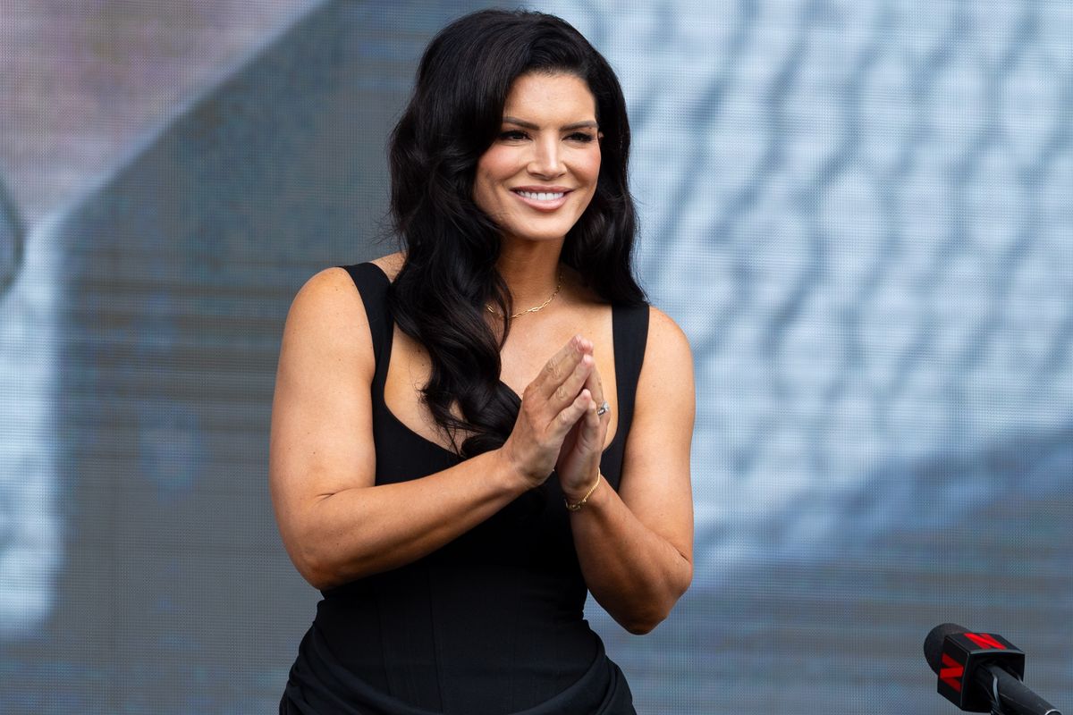 MMA fighter and actress Gina Carano gestures to the crowd after being introduced during a pre-fight press conference for a Netflix fight, Tuesday March 10, 2026 in Inglewood, Calif.