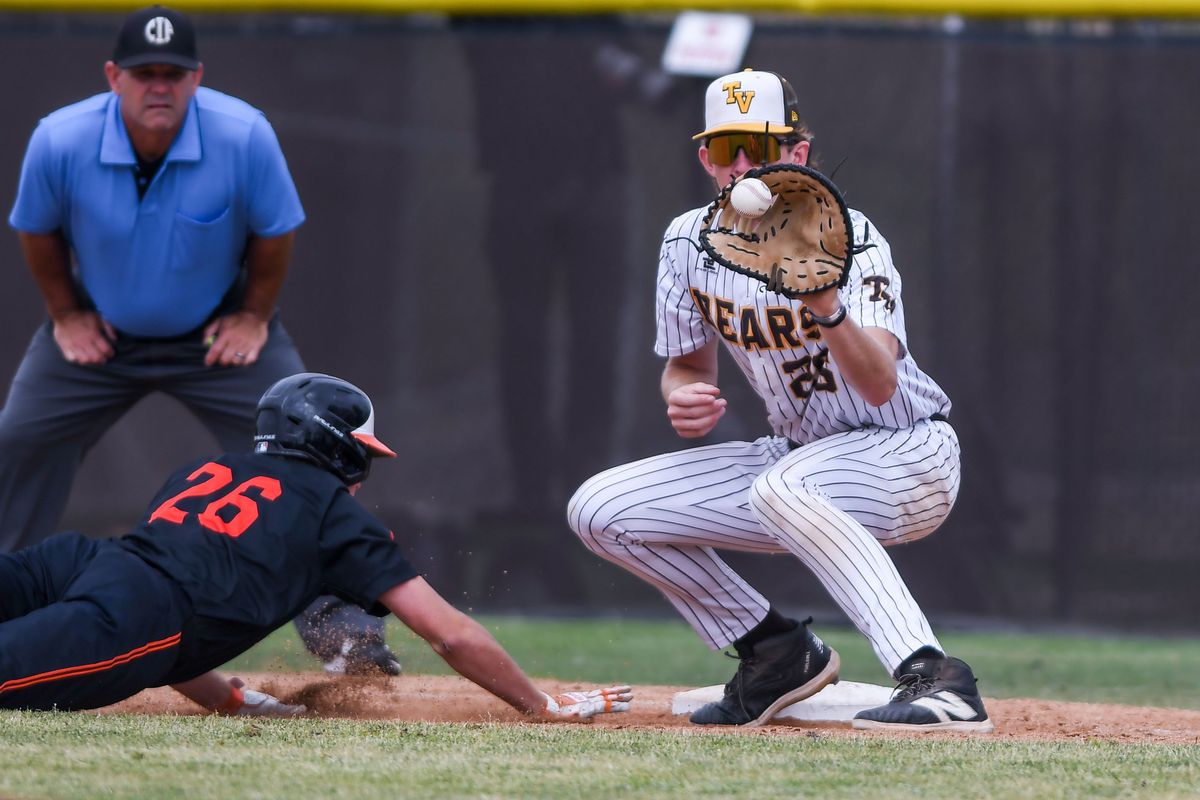 Huntington Beach Tanner Brown (26) dives back to first on a pick off attempt during an High School Baseball game against  Temecula Valley Tuesday May 12, 2026 in Temecula, California.