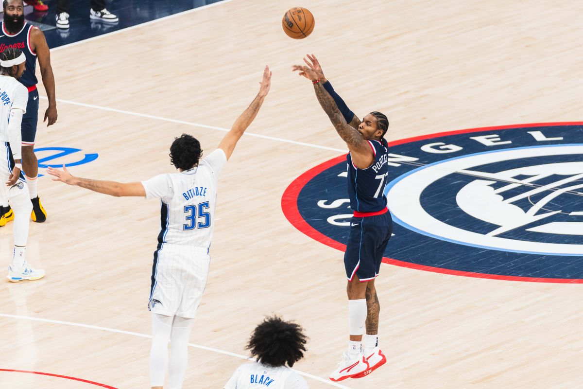 LA Clippers Guard Kevin Porter Jr. (77) taking a three point attempt during an NBA basketball game against the Orlando Magic, Wednesday November 20th, 2024 in Inglewood, California. 