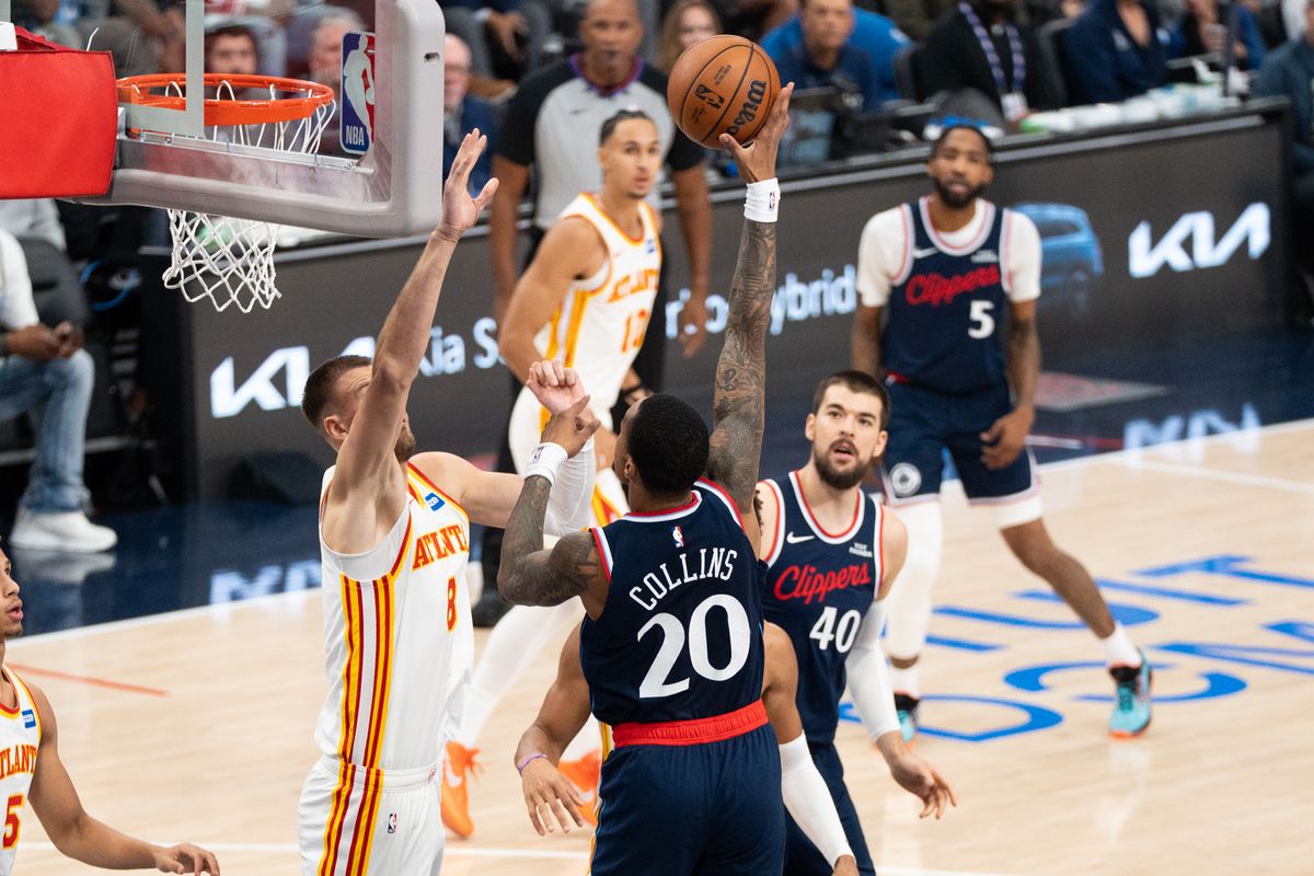 Los Angeles Clippers forward John Collins (20) shoots a sky hook over the defender at an NBA basketball game against the Atlanta Hawks, Monday November 10th, 2025 in Inglewood, California. 