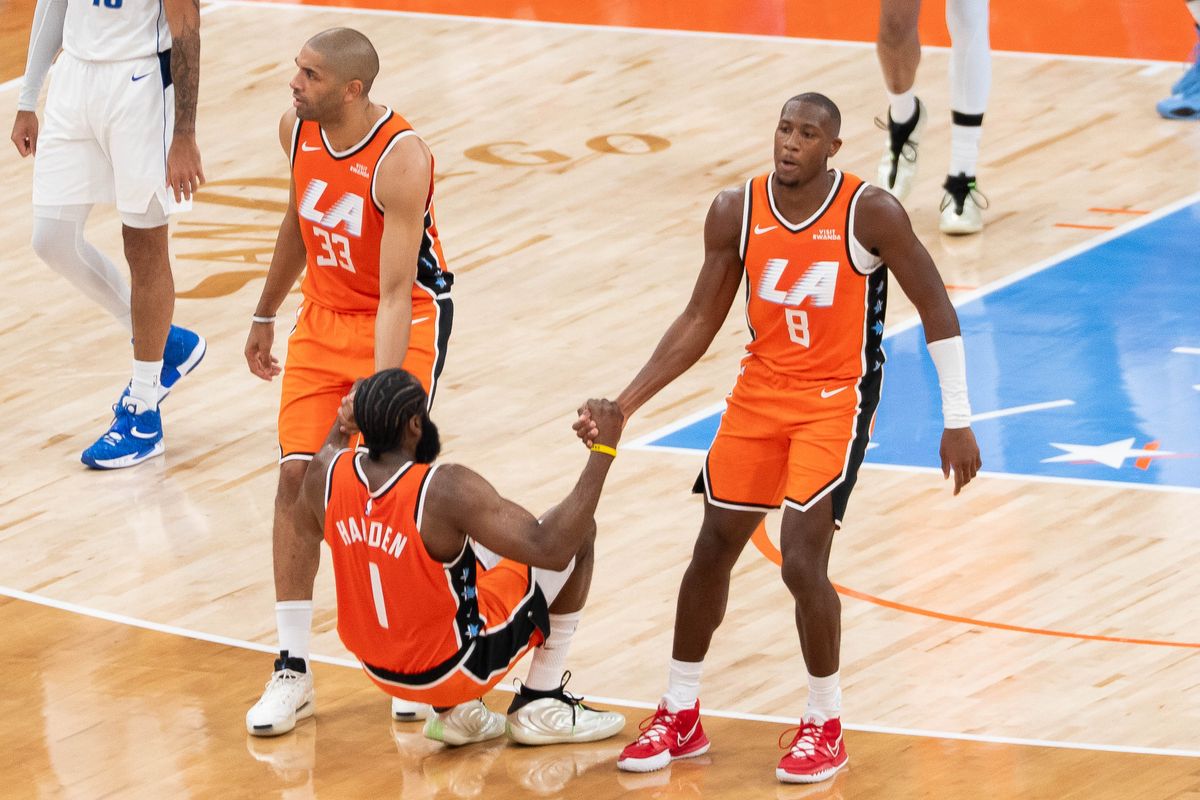 Los Angeles Clippers guard Kris Dunn (8) and forward Nico Batum (33) helping up guard James Harden (1) at an NBA basketball game against the Dallas Mavericks, Saturday November 29th, 2025 in Inglewood, California. 