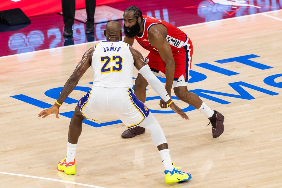 James Harden #1 of the LA Clippers handles the ball while being guarded by LeBron James #23 of the Los Angeles Lakers during an NBA basketball game, Saturday December 20, 2025 in Inglewood, Calif.