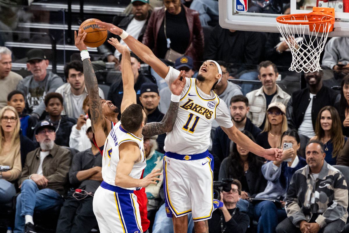 Jaxson Hayes #11 and Maxi Kleber #14 of the Los Angeles Lakers attempt to block a shot during an NBA basketball game against the LA Clippers, Saturday December 20, 2025 in Inglewood, Calif.