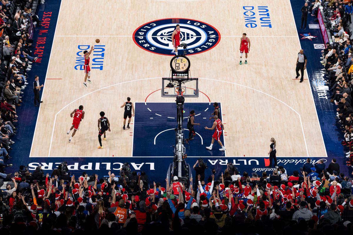 Kobe Sanders #4 of the LA Clippers shoots a three pointer in front of The Wall fan section at Intuit Dome during an NBA basketball game against the Houston Rockets, Tuesday December 23, 2025 in Inglewood, Calif.