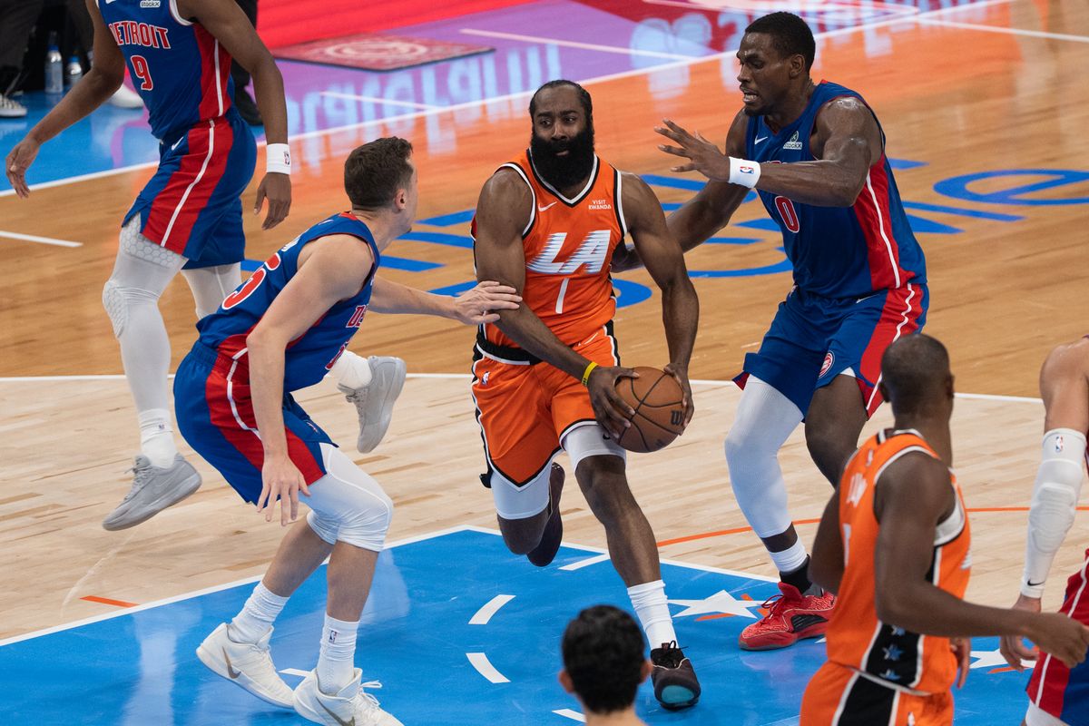 Los Angeles Clippers Guard James Harden (1) attacks the rim on two defenders during an NBA basketball game against the Detroit Pistons, Sunday December 28th, 2025 in Inglewood, California. 