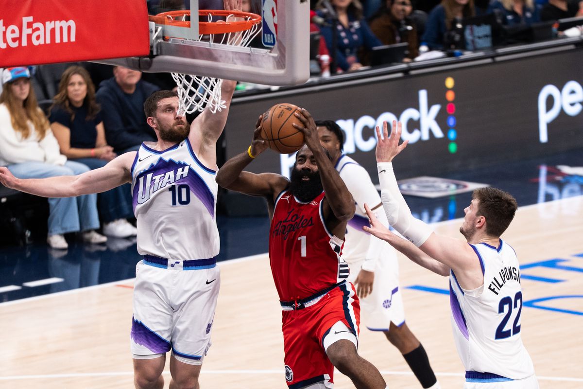 Los Angeles Clippers Guard James Harden (1) attacks the rim of three defenders and scores during an NBA basketball game against the Utah Jazz, Thursday January 1st, 2026 in Inglewood, California. 