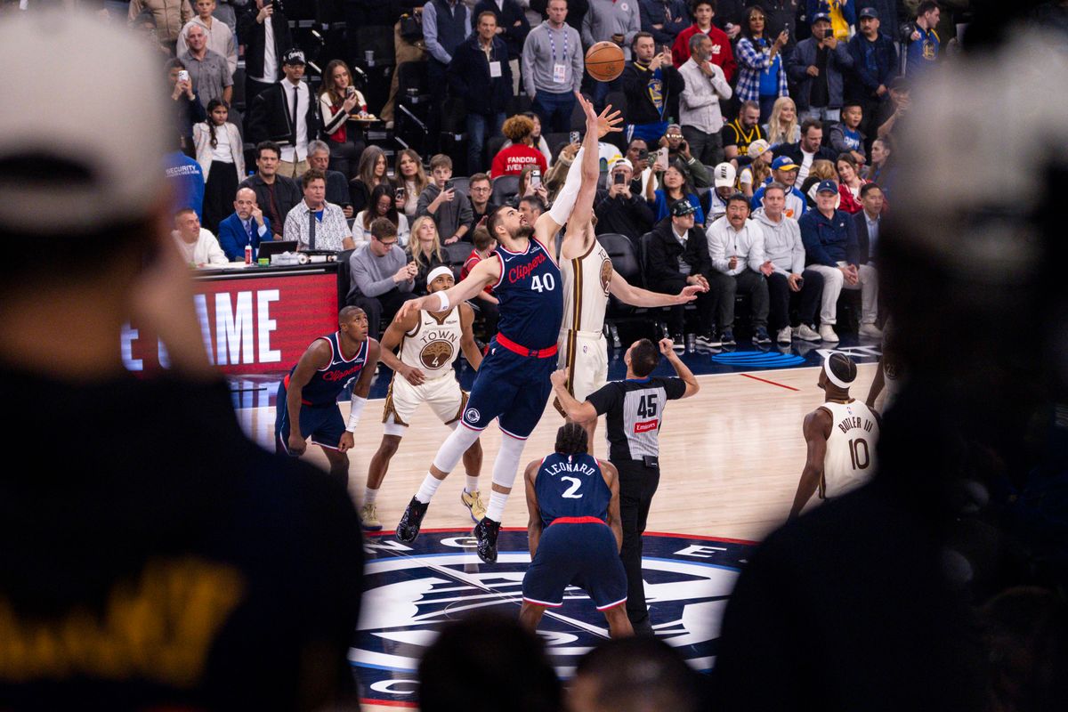 Ivica Zubac #40 of the LA Clippers and Quinten Post #21 of the Golden State Warriors jump for the opening tip during an NBA basketball game, Monday January 5, 2026 in Inglewood, Calif.