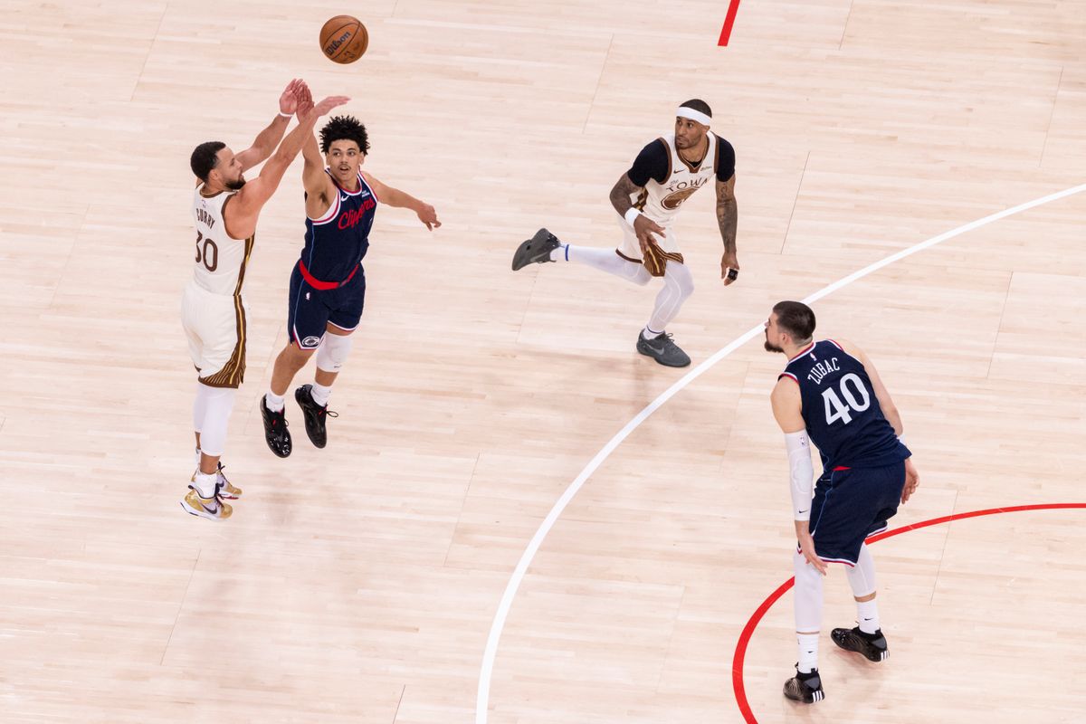 Stephen Curry #30 of the Golden State Warriors shoots a long three pointer over Kobe Sanders #4 of the LA Clippers during an NBA basketball game, Monday January 5, 2026 in Inglewood, Calif.