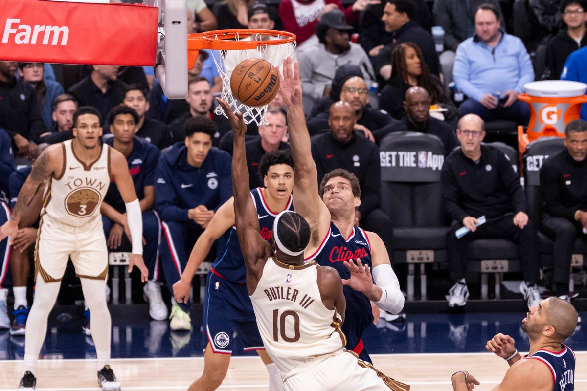 Jimmy Butler III #10 of the Golden State Warriors tries to lay the ball up over Brook Lopez #11 of the LA Clippers during an NBA basketball game, Monday January 5, 2026 in Inglewood, Calif.