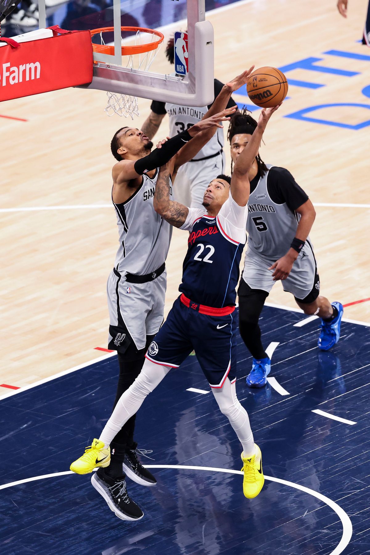 Jordan Miller #22 of the LA Clippers lays the ball up over Victor Wembanyama #1 of the San Antonio Spurs during an NBA basketball game, Monday March 16, 2026 in Inglewood, Calif. Jordan Miller #22 of the LA Clippers lays the ball up over Victor Wembanyama #1 of the San Antonio Spurs during an NBA basketball game, Monday March 16, 2026 in Inglewood, Calif.