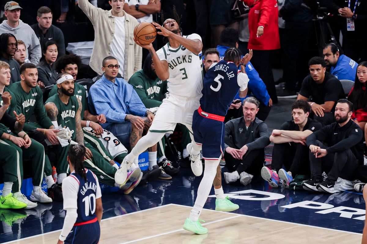 Myles Turner #3 of the Milwaukee Bucks attempts a three pointer while being fouled by Derrick Jones Jr. #5 of the LA Clippers during an NBA basketball game, 2026 in Inglewood, Calif.