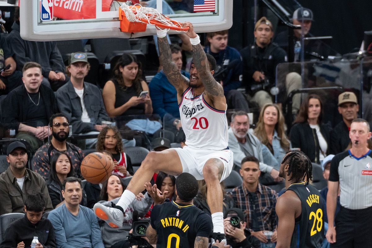 Los Angeles Clippers forward John Collins (20) dunks the ball during an NBA basketball game against the Golden State Warriors,Sunday April 12th, 2026 in Inglewood, California. 